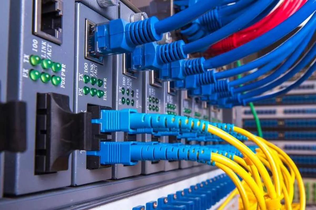 Copper and fiber patch cables terminated into a network switch on a DigiCo low voltage installation
